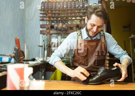 Male Shoes Cleaner With Cloth For Black Leather Polished Derby Shoes  Cleaning Working In Workshop Horizontal Image Orientation Stock Photo -  Download Image Now - iStock