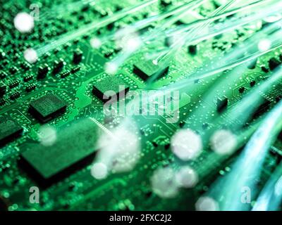 Fibre optics carrying data being transferred to desktop computer Stock Photo