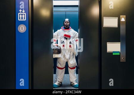 Male astronaut standing in elevator Stock Photo