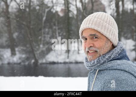 Smiling man wearing knit hat at park Stock Photo