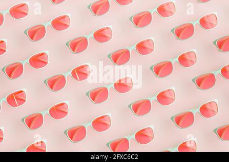 Three dimensional pattern of rows of pink sunglasses Stock Photo