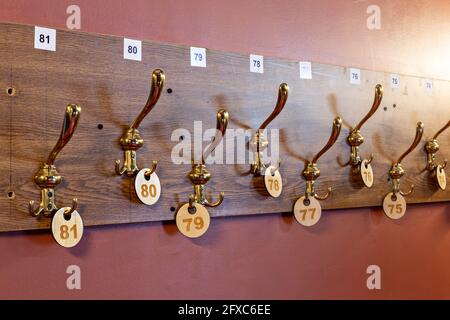 Number labels hanging on hooks in stage theater cloakroom Stock Photo