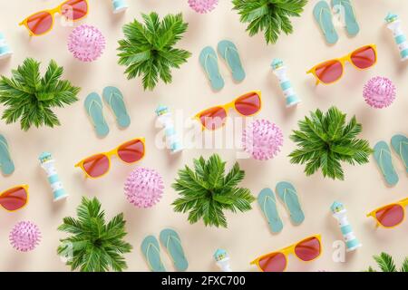 Three dimensional pattern of palm trees, sunglasses, flip-flops, lighthouses and COVID-19 cells Stock Photo