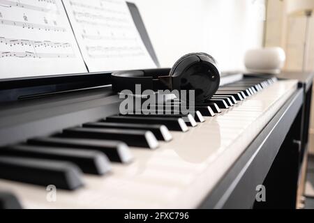 Wireless headphones on piano keyboard Stock Photo