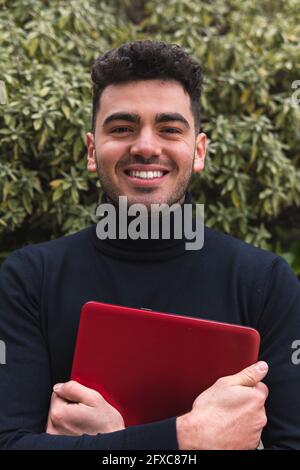 Smiling male entrepreneur with laptop Stock Photo