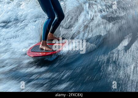 Legs of woman wakesurfing in Moskva river Stock Photo