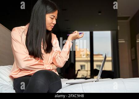 Businesswoman brainstorming while using laptop in hotel Stock Photo