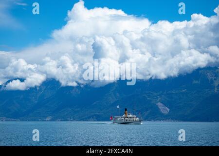 One of the famous paddle steamers on Lac Leman in front of the mountains Stock Photo