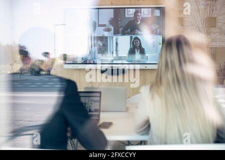 Business professionals on video conference meeting in office Stock Photo