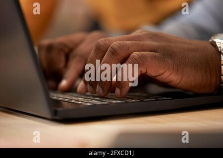 Man typing on laptop at office Stock Photo