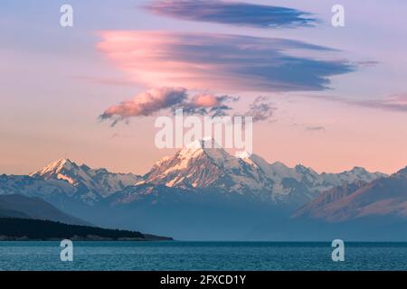 New Zealand, Canterbury, Majestic Mount Cook towering over blue waters of Lake Pukaki at sunset Stock Photo