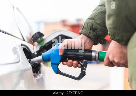 Man refueling car at gas station Stock Photo