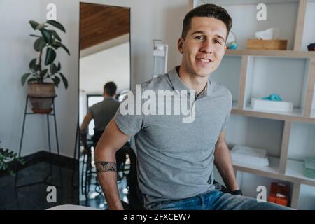 Young man sitting on wheelchair in medical practice Stock Photo