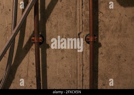 Copper Pipes of a Basement Laundry Sink Stock Photo