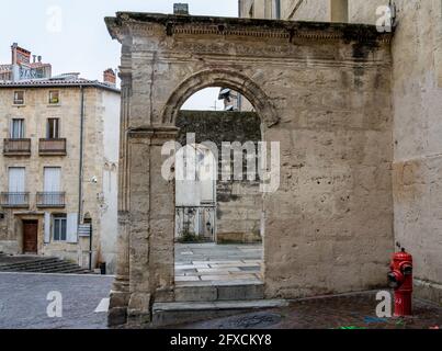 View of and small town square in France on a wet day - red fire hydrant Stock Photo