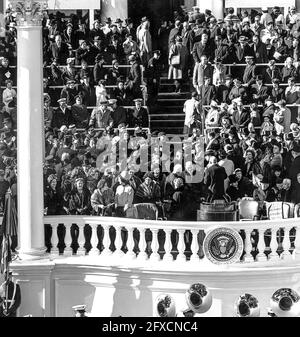 Presidential Inauguration of John F. Kennedy at East Portico, United States Capitol Building, Washington, D.C. Jacqueline Kennedy talks with Lady Bird Johnson as they await arrival of President-elect John F. Kennedy and Vice President-elect Lyndon B. Johnson. Behind them: John F. Kennedy's sister Eunice Kennedy Shriver; her husband R. Sargent Shriver; and Attorney General-designate Robert F. Kennedy. Stock Photo