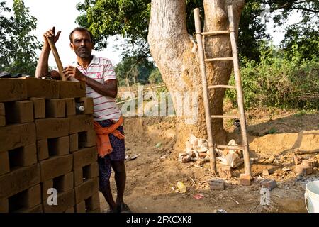 Men making clay bricks by hand in a rural village in Nayagarh, Odisha. Stock Photo