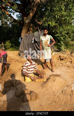 Men making clay bricks by hand in a rural village in Nayagarh, Odisha. Stock Photo