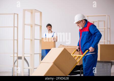 Two professional movers doing home relocation Stock Photo