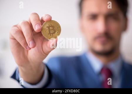 Man earning money via Internet in cryptocurrency concept Stock Photo