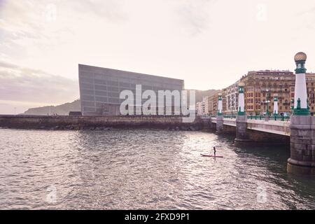 Man practicing paddle surf in San Sebastian nera Kursaal building Stock Photo