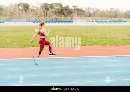 Strong handicapped athlete running on stadium Stock Photo
