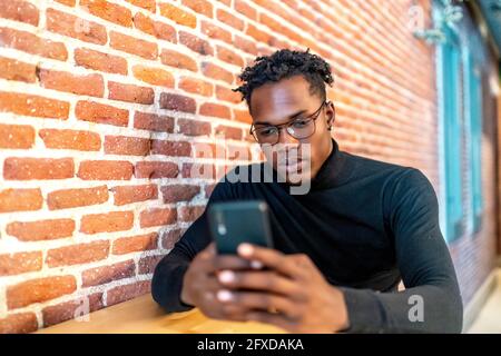 young african man working from his smartphone Stock Photo
