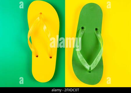 green and yellow rubber slippers on green and yellow background Stock Photo
