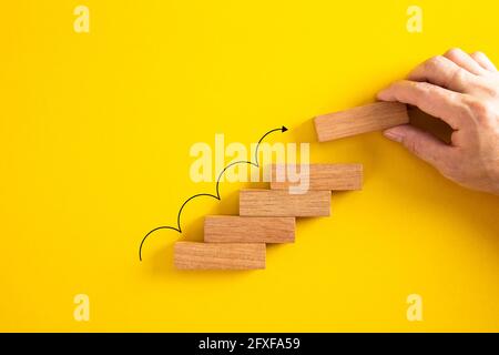 Hand arranging wood block with arrow up icon. Business concept growth ...