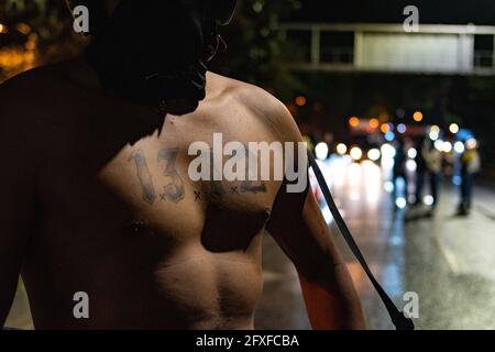 Medellin, Colombia. 26th May, 2021. A demonstrator shows a tattoo with the number '1312' which simbolizes the acronym against police (ACAB) in a performing arts demonstration as artists and demonstrators protested against the government of president Ivan Duque Marquez and the abuse of force by police that leads to at least 40 dead across the country since the nation wide antigovernment protests started. In Medellin, Colombia on May 26, 2021. Credit: Long Visual Press/Alamy Live News Stock Photo