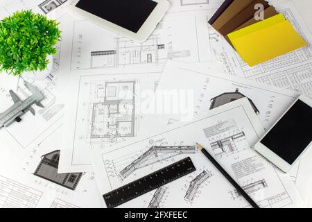 Engineering and architecture drawings on workplace. Architect Desk with Engineering blueprint. Plan drawings. Stock Photo