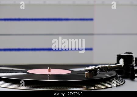 Vinyl record and turntable during analog to digital audio conversion ...