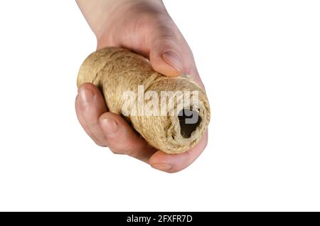 A man is holding a roll of twine. Hand with coiled twine isolated on white background. Stock Photo