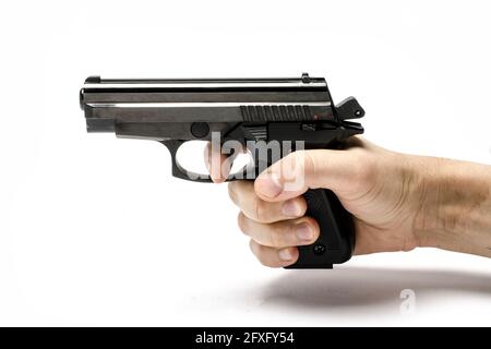 Gun, pistol in hand isolated on white Stock Photo