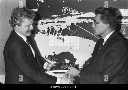 Van Dijk (r) receives booklet on the law of private equity from author mr. drs. A. A. M. Dolle, December 10, 1985, The Netherlands, 20th century press agency photo, news to remember, documentary, historic photography 1945-1990, visual stories, human history of the Twentieth Century, capturing moments in time Stock Photo