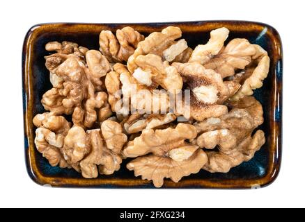 top view of peeled walnuts in bowl cutout on white background Stock Photo
