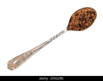 top view of dark brown muscovado sugar in silver teaspoon cutout on white background Stock Photo