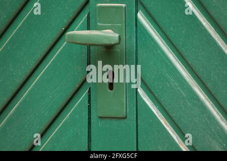 Keyhole for the key on the green gate. Stock Photo