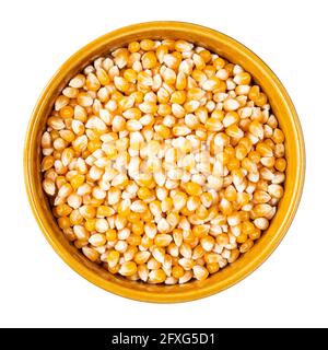 top view of raw maize (corn) seeds in round bowl cutout on white background Stock Photo