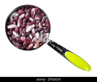 top view of red speckled kidney bean in measuring cup cutout on white background Stock Photo