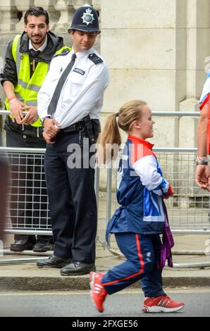 Ellie Simmonds of Team GB Olympians leaving Buckingham Palace after the victory parade. London 2012 Olympics. Police officer looking down Stock Photo