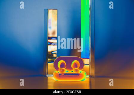 Wireless blue headphones with a prism background. Negative adgy filter Stock Photo