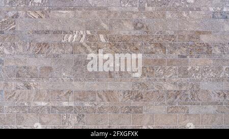 Decor of a wall with rows of brown patterned tiles Stock Photo