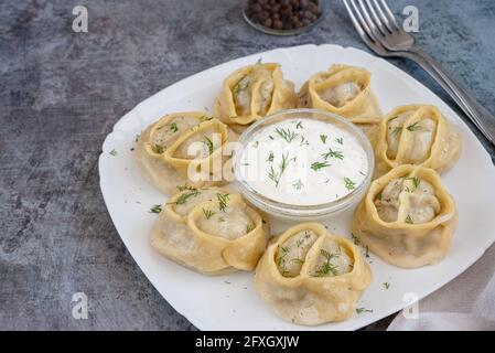 Top view of manti with lamb meat. Delicious uzbek dumplings on a white plate Stock Photo