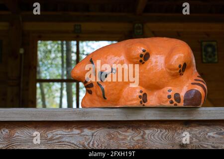 Opishnya, Poltava region, Ukraine - May 16, 2021: Red cat sleeping on the window. Opishnya National Museum-Reserve of Ukrainian Ceramics Stock Photo
