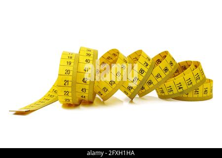 macro of tangled yellow measure tape isolated on white background Stock Photo