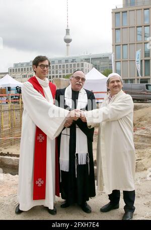 Berlin, Germany. 27th May, 2021. Pastor Gregor Hohberg (l-r), Rabbi Andreas Nachama and Imam Kadir Sanci stand in front of the remains of St. Peter's Church, which was destroyed during the war, in Berlin's Mitte district and take part in the laying of the foundation stone for the multi-religious 'House of One' building in Berlin. The House of One is a sacred building with a synagogue, a church and a mosque under one roof. Credit: Wolfgang Kumm/dpa/Alamy Live News Stock Photo