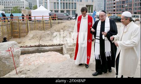 Berlin, Germany. 27th May, 2021. Pastor Gregor Hohberg (l-r), Rabbi Andreas Nachama and Imam Kadir Sanci stand in front of the remains of St. Peter's Church, which was destroyed during the war, in Berlin's Mitte district and take part in the laying of the foundation stone for the multi-religious 'House of One' building in Berlin. The House of One is a sacred building with a synagogue, a church and a mosque under one roof. Credit: Wolfgang Kumm/dpa/Alamy Live News Stock Photo