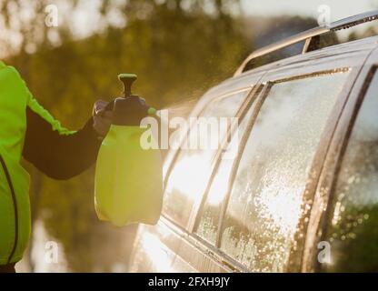 a man washes a car under water pressure. manual car wash Stock Photo