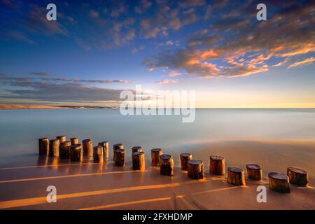 FRANCE. GIRONDE (33), CAP FERRET, PEGS IN THE SAND ON THE BEACH OF CAP FERRET AT SUNSET Stock Photo